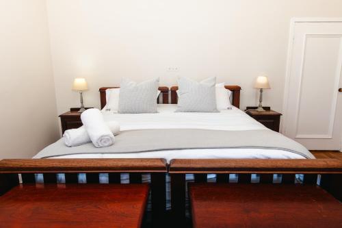 a bedroom with a bed with white sheets and pillows at Botha House in Pennington
