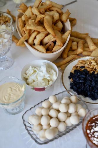 a table with french fries and other dishes of food at guest House Nur Emgekchil in Emgekchil