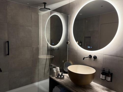 a bathroom with a large sink and a mirror at hirschen dornbirn - das boutiquestyle hotel - skyrelax & wellness im rooftop in Dornbirn