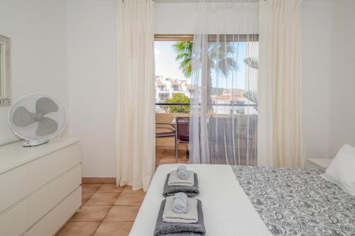 a bedroom with a bed and a window with a view at Castle Harbour with heated pool ap Patricia in Los Cristianos