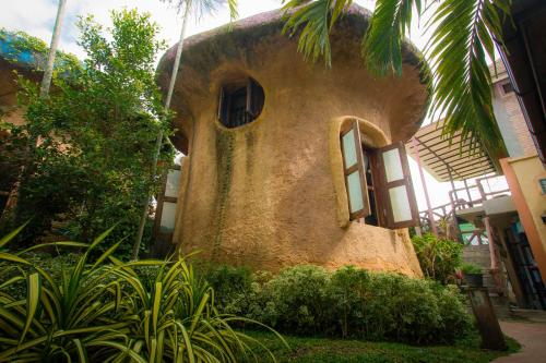 an old house with a palm tree in front of it at Leafy Greens Chiangmai in Chiang Mai