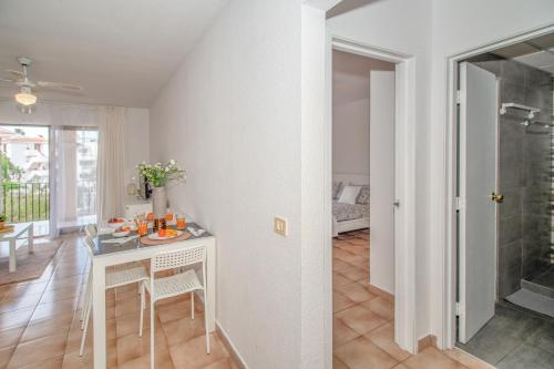 a kitchen and living room with a table and chairs at Castle Harbour with heated pool ap Patricia in Los Cristianos