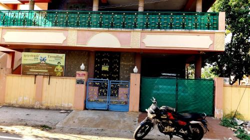 a motorcycle parked in front of a building at Sri Subham Stay in Thanjāvūr