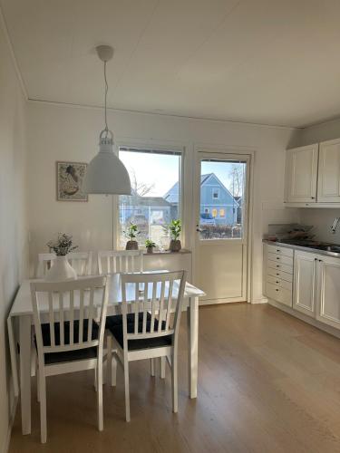 a kitchen and dining room with a white table and chairs at large Villa In Central Motala in Motala