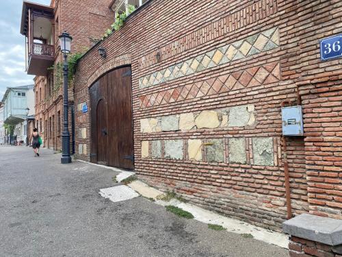 a brick building with a door on the side of it at Boutique Hotel Tiflis in Tbilisi City