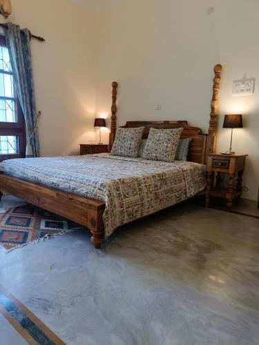 a bedroom with a large bed in a room at the Kutumb- Where the Himalayas come alive! in Pālampur