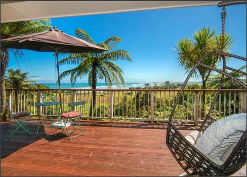 a porch with a hammock and a view of the ocean at Coastal Ridge Retreat in Charleston