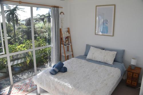 a bedroom with a bed and a large window at Coastal Ridge Retreat in Charleston
