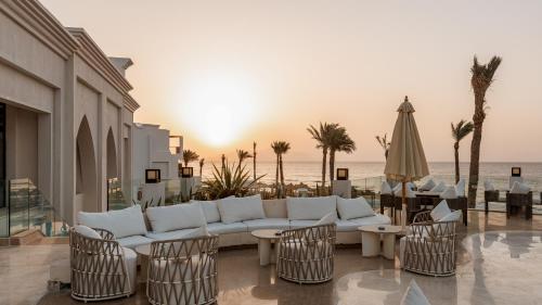 a living room with a couch and chairs and the ocean at Sunrise Remal Beach Resort in Sharm El Sheikh