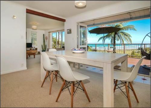 a dining room with a table with chairs and an umbrella at Coastal Ridge Retreat in Charleston