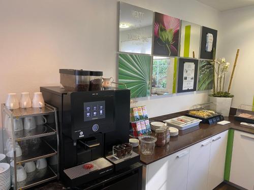 a kitchen with a coffee maker on a counter at Businesshotel Lux in Luzern