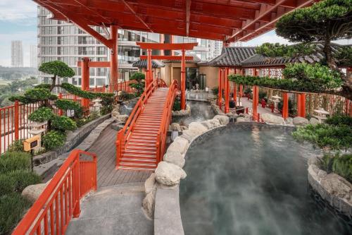 a pool in a resort with a water slide at Leng - Duplex Onsen Swanlake Ecopark in Kim Quan