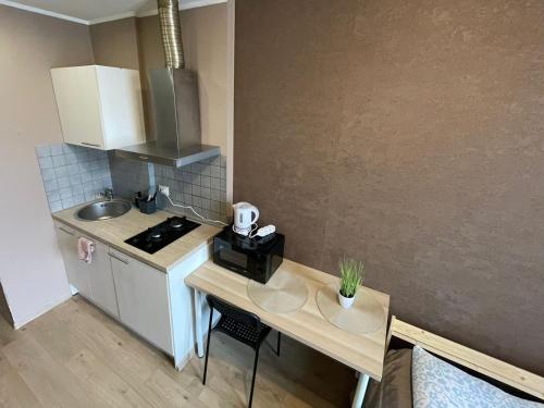 a small kitchen with a table and a counter top at Kopli Apartment in Tallinn