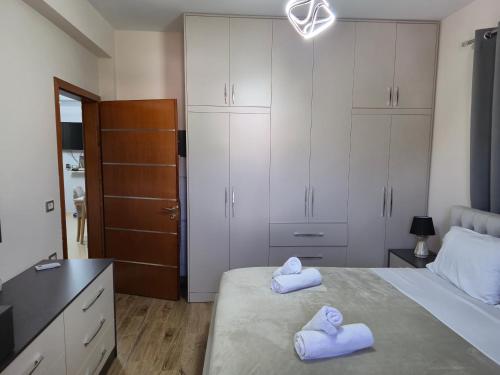 a bedroom with two towels on a bed at Villa Ari in Berat