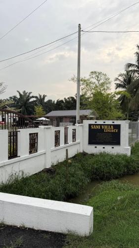 a sign for the salt wheelery on a white fence at Studio Suites Sani Villa Legacy in Pelabohan Klang