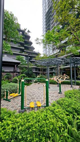 a park with yellow chairs and a pavilion in a city at Leng - Duplex Onsen Swanlake Ecopark in Kim Quan