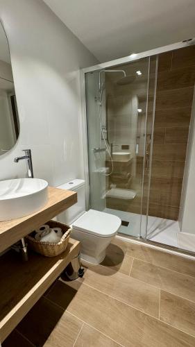 a bathroom with a toilet and a glass shower at Casa Martina in Zaragoza