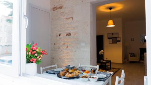 a table with a plate of food on it at Domus 21 - DIEMME STAY in Alberobello