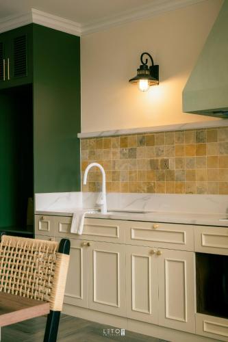 a kitchen with a sink and a counter top at Leng - Duplex Onsen Swanlake Ecopark in Kim Quan