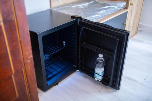 a bottle of water sitting inside of a black cabinet at Villa Giove Rooms in Prato