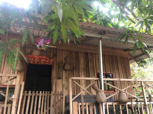a small wooden house with a window and flowers on it at Sok Phen Homestay in Siem Reap