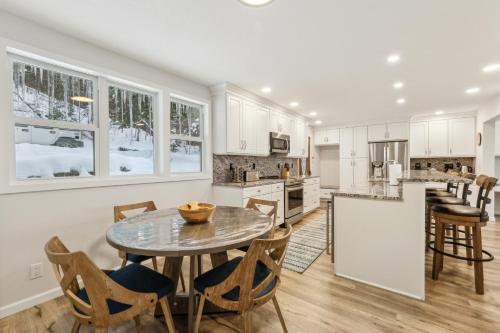 a kitchen and dining room with a table and chairs at Beautiful Torch Lake House with Beach Access home in Rapid City