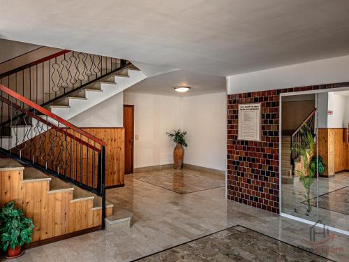 a hallway with a staircase and a brick wall at Mare 400m - Free Parking - WiFi in Varazze
