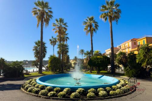 a fountain in a park with palm trees at Mare 400m - Free Parking - WiFi in Varazze