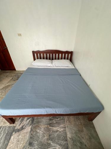 a bed with a blue mattress in a room at Sea LaVie Guesthouse in Siquijor