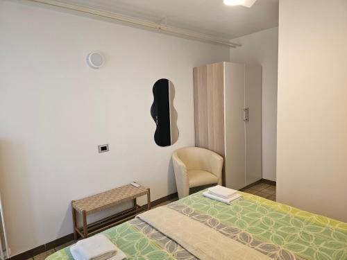 a bedroom with a bed and a guitar on the wall at Apartments Vila Toni in Portorož