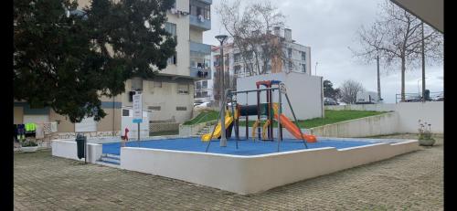 a playground with a slide in a building at Charming T1 apartment in Seixal in Aldeia de Paio Pires