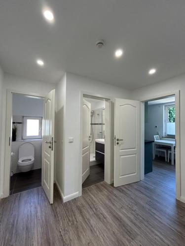 a white bathroom with a toilet and a sink at Ferienwohnung am Uniklinik Lübeck in Lübeck