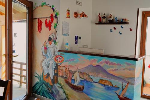 a large painting on the wall of a room at San Giacomo Relais in Furore