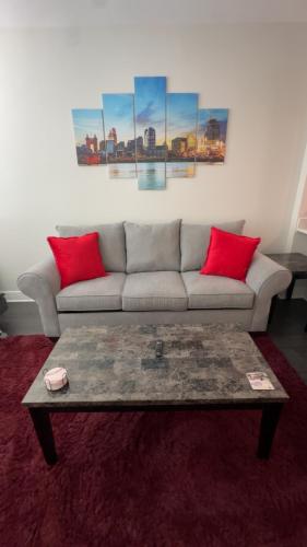 a living room with a couch and a coffee table at The 513 Flat-1BR, 1 Bath Apmt with Pool and Riverfront View Only Steps from The banks & Stadiums in Cincinnati