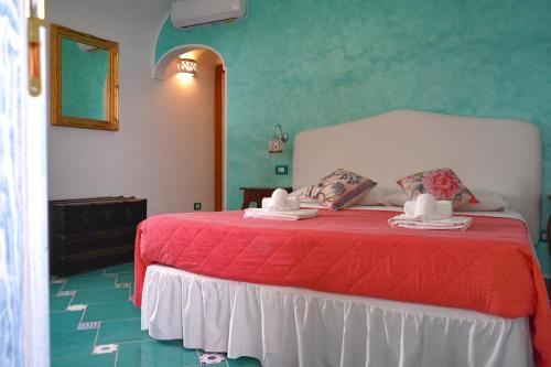 a bedroom with a bed with a red bedspread at San Giacomo Relais in Furore