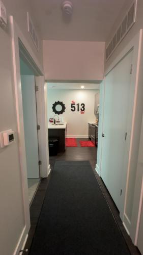 an empty hallway with a room with a desk at The 513 Flat-1BR, 1 Bath Apmt with Pool and Riverfront View Only Steps from The banks & Stadiums in Cincinnati
