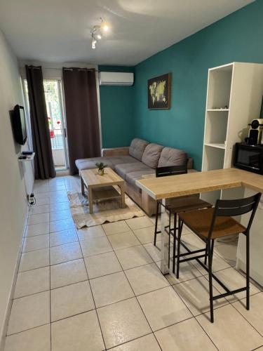 un salon avec un canapé et une table dans l'établissement Logement proche de la plage, à Nice