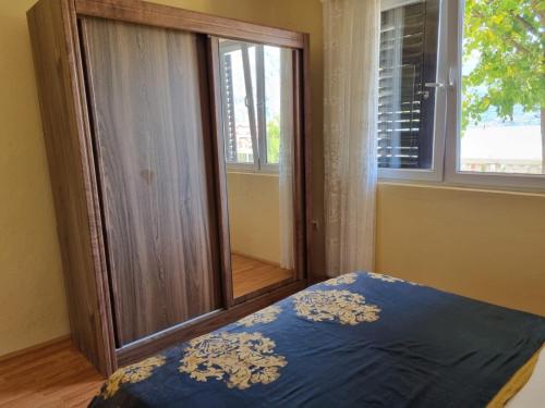 a bedroom with a bed in front of a window at Bosko in Kotor