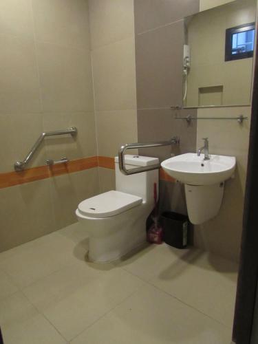 a bathroom with a toilet and a sink at Regner-Quinto Real Estate Services in Cebu City