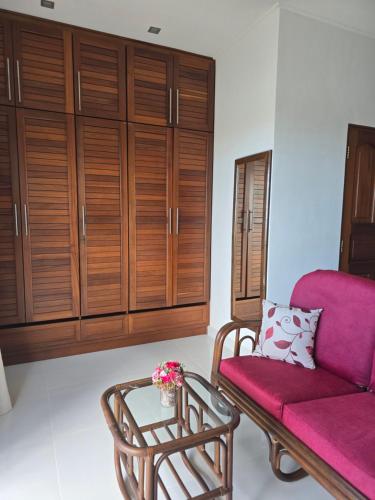 a living room with a couch and a table at Emma's Guest House and Self-Catering in Au Cap