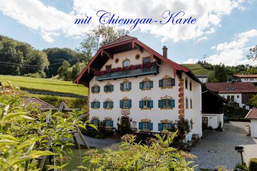 a white house with a red roof at Pension Ober in Siegsdorf