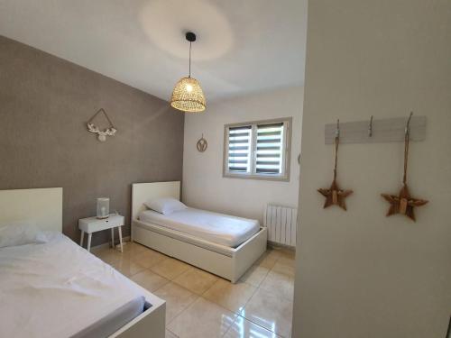 a bedroom with a bed and a window at La Romarine in Salernes