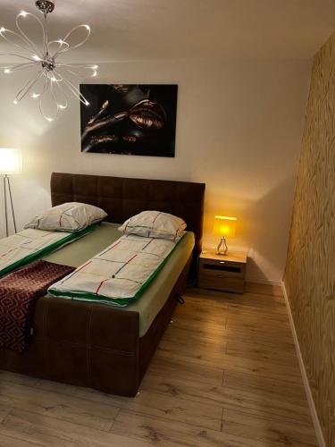 a bedroom with a bed and a chandelier at Anelia City Apartment 2 Zimmer inkl 2 Parkplätze im Zentrum in Paderborn