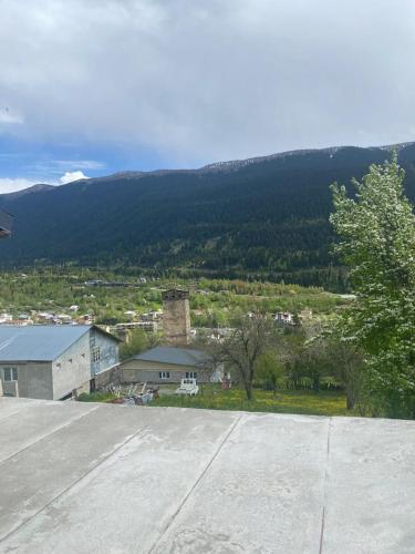 an empty parking lot with mountains in the background at Nadia Guesthouse in Mestia