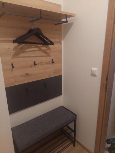 a closet with a wooden wall and a bench at Landhaus Seppi in Presseggersee