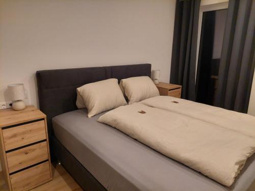 a bed with two pillows on it in a bedroom at Landhaus Seppi in Presseggersee