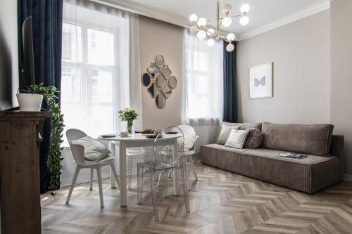 a living room with a couch and a table at Polpo Apartments B&B in Łódź