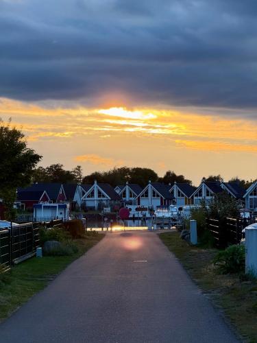 a road leading to a row of houses at sunset at Hyggely Marie Sophie in Wandlitz