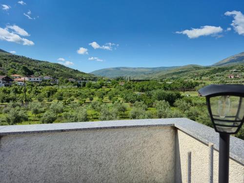 a view of a valley from a balcony with a street light at Villa Ari in Berat