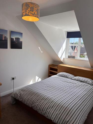 a bedroom with a bed and a large window at Spacious four bed detached home in Nottingham in Nottingham